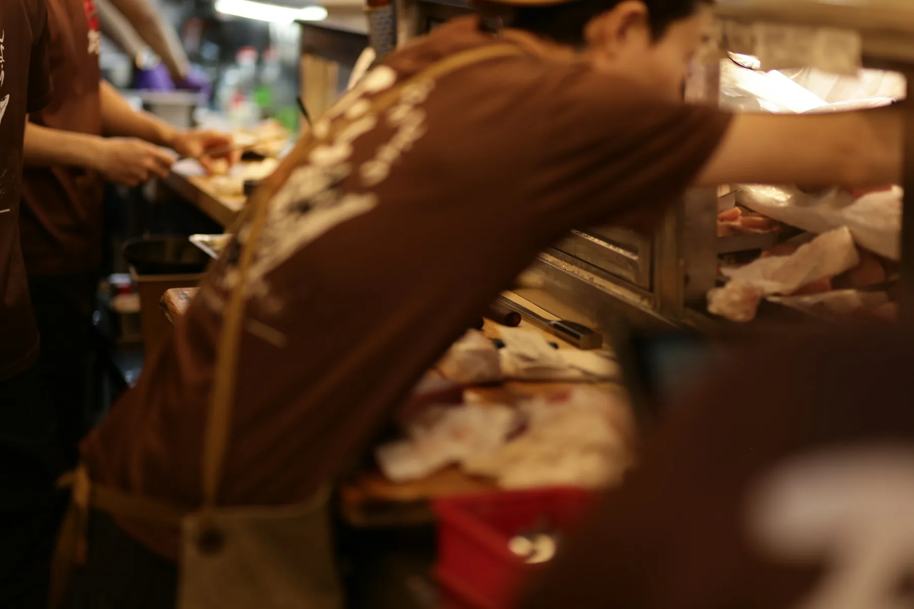 Restaurant staff prepare food during a working kitchen service.