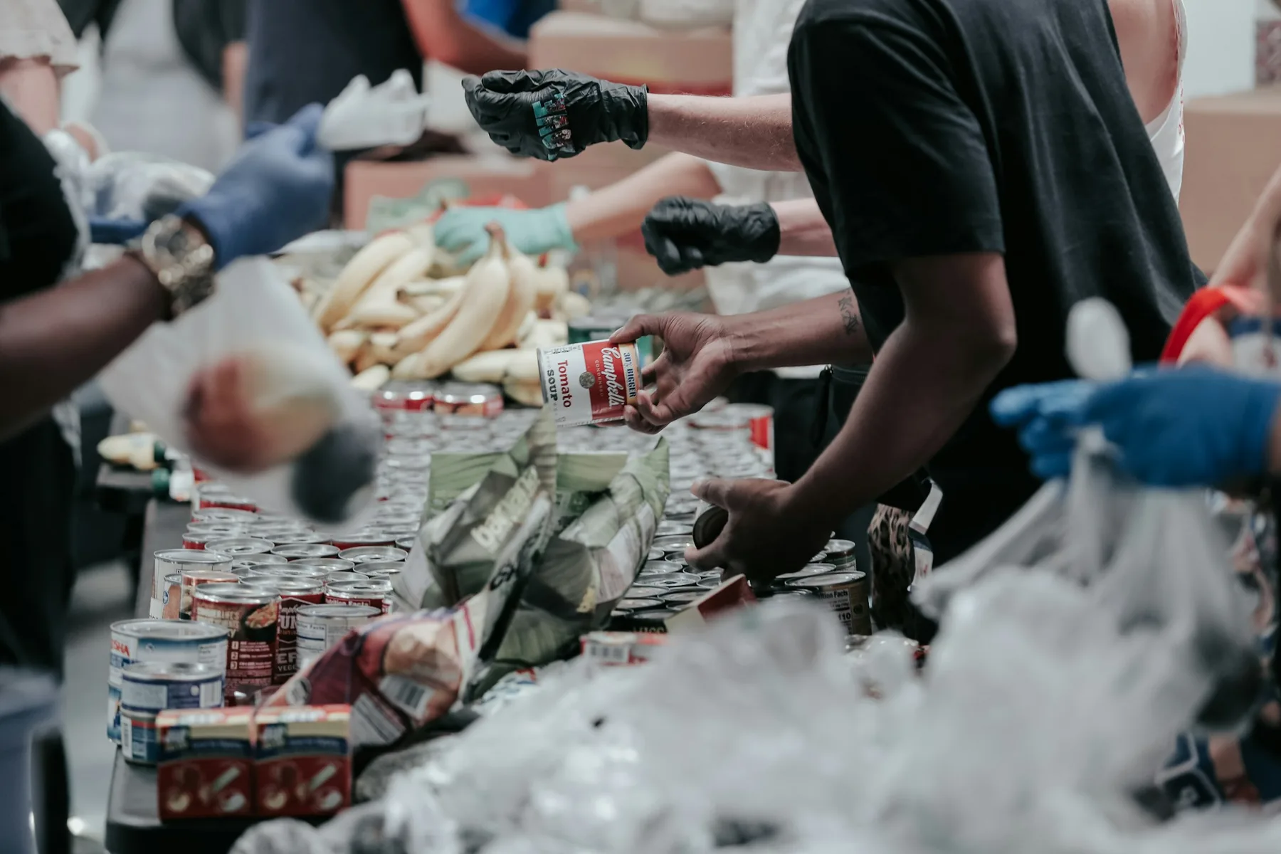 Volunteers sort shelf-stable food together at a community event.