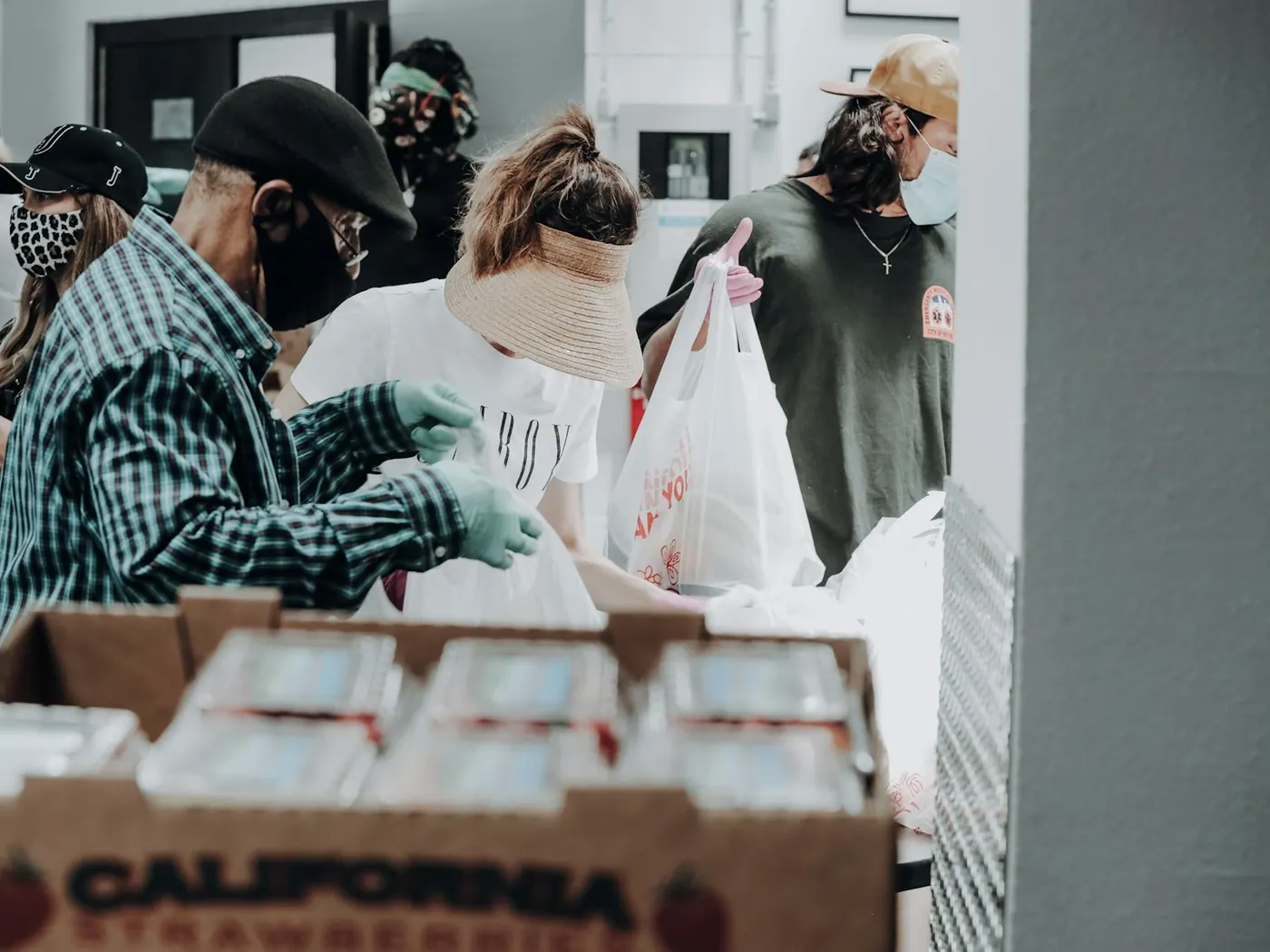Volunteers organize packaged food for distribution.